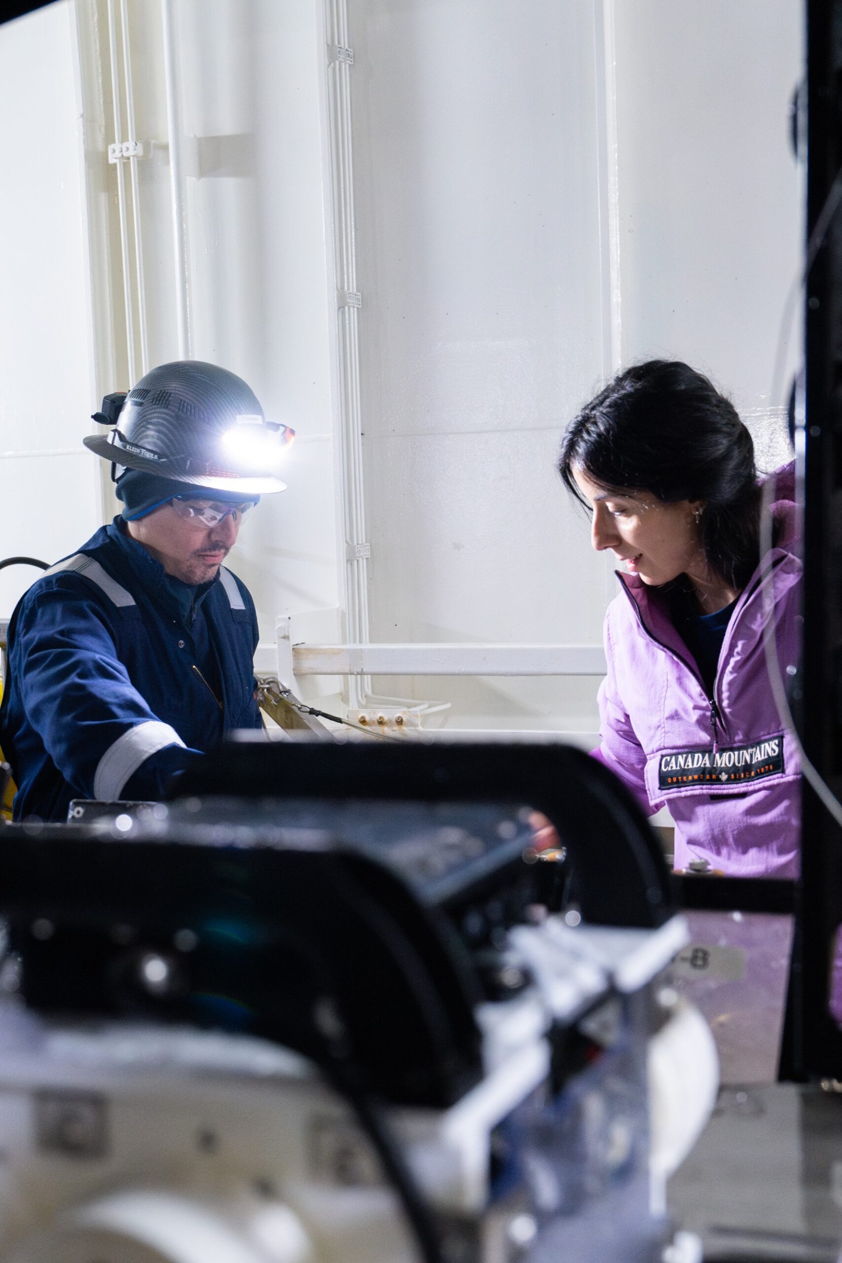 ROV technician Leo Alcantara helps Renata Pertossi, postdoctoral researcher at CONICET to retrieve samples from ROV SuBastian