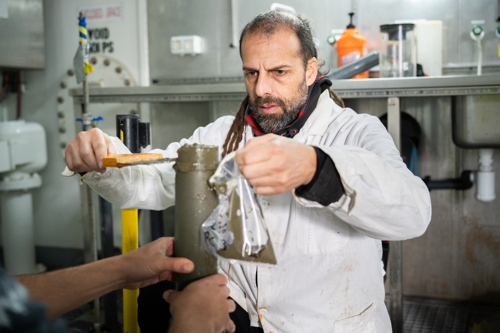 Diego Urteaga, assistant researcher at CONICET, extracts a sample of sediment from a push core extracted by ROV SuBastian. .
CREDIT: Misha Vallejo Prut / Schmidt Ocean Institute